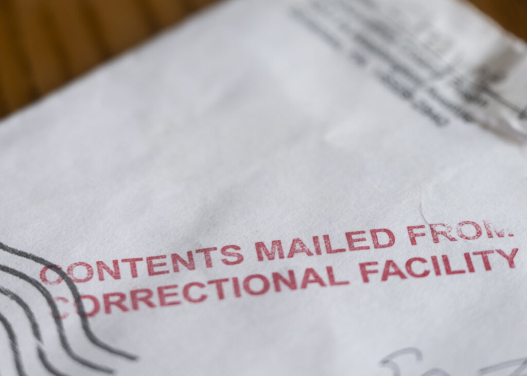 A photo of an envelope stamped in red with the words: content mailed from correctional facility