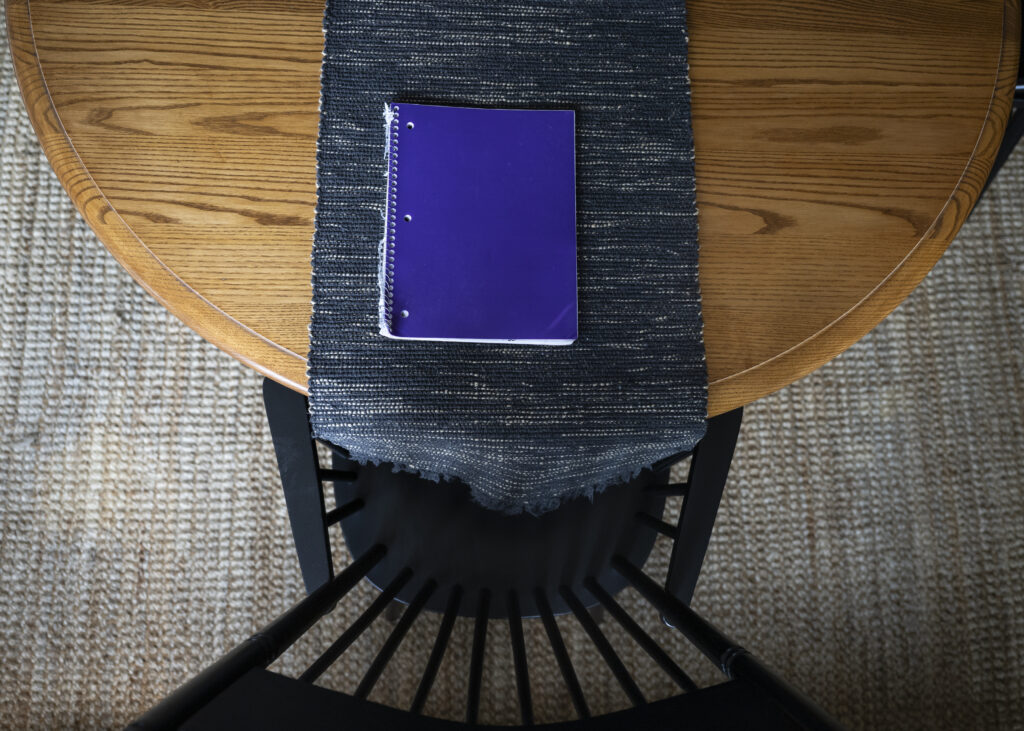 A photo of a purple notebook on a table.